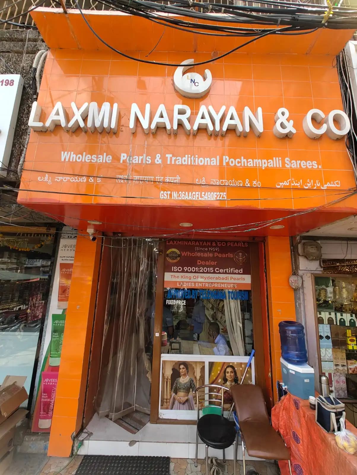 Entrance to Laxminarayan & Co Pearls beneath the orange storefront sign