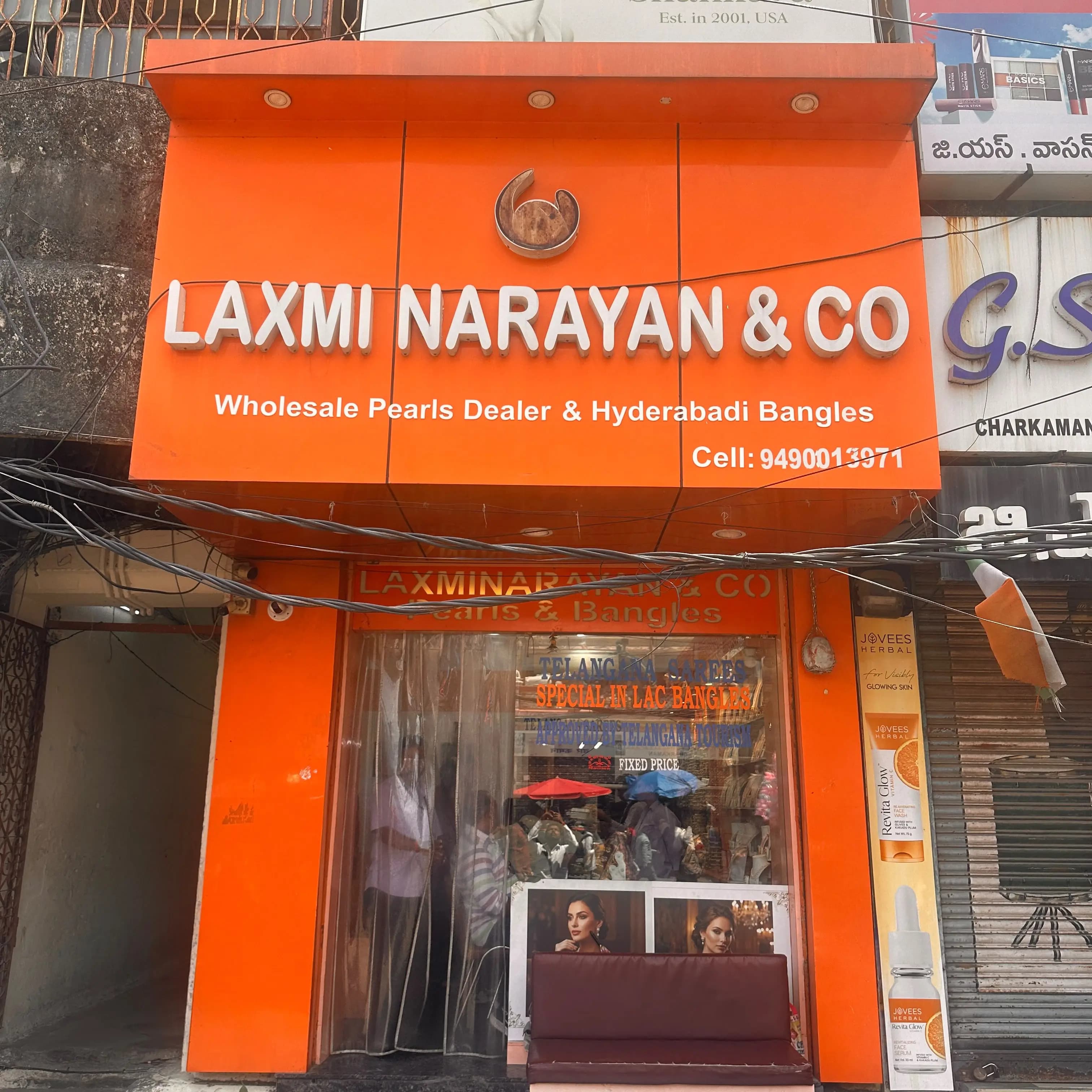 Laxminarayan & Co Pearls storefront with its orange signboard
